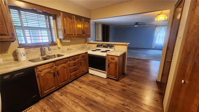 2704 S Taylor St, Pittsburg, KS 66762 - kitchen with white electric range oven, black dishwasher, a peninsula, dark wood-style flooring, and light countertops