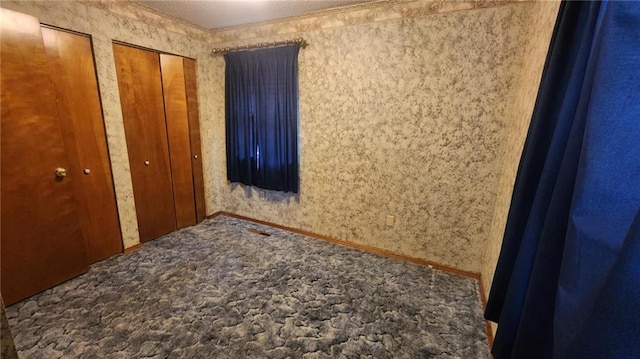 2704 S Taylor St, Pittsburg, KS 66762 - unfurnished bedroom with carpet flooring and two closets