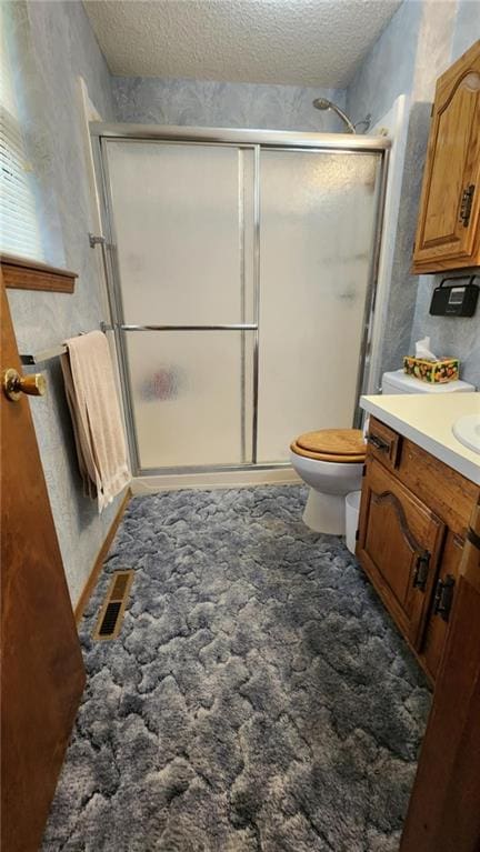 2704 S Taylor St, Pittsburg, KS 66762 - full bathroom with vanity, a textured ceiling, and a shower stall