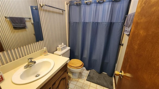2704 S Taylor St, Pittsburg, KS 66762 - full bath with wallpapered walls, vanity, curtained shower, and tile patterned floors