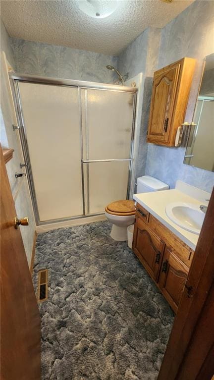 2704 S Taylor St, Pittsburg, KS 66762 - bathroom with vanity, a shower stall, and a textured ceiling