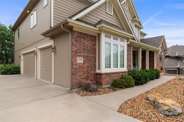 2704 SW Gray Ln, Lees Summit, MO 64081 - view of side of property with brick siding, a garage, and concrete driveway