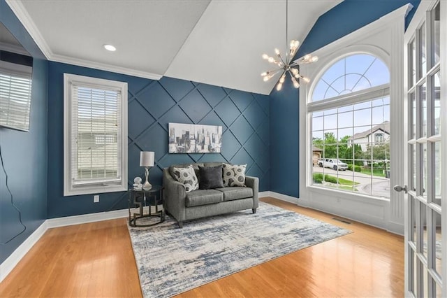 2704 SW Gray Ln, Lees Summit, MO 64081 - living area with an accent wall, baseboards, wood finished floors, crown molding, and lofted ceiling