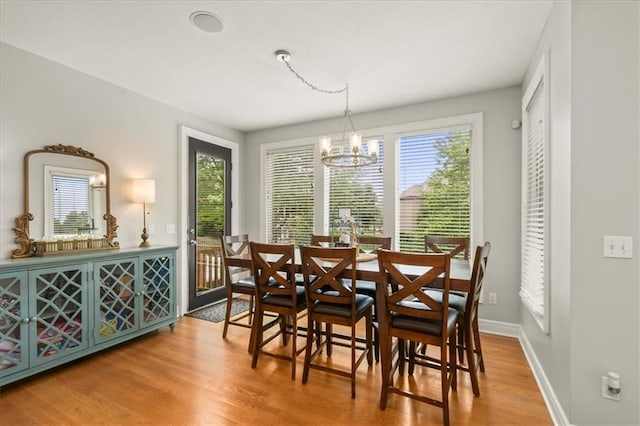 2704 SW Gray Ln, Lees Summit, MO 64081 - dining room with wood finished floors, a chandelier, and baseboards