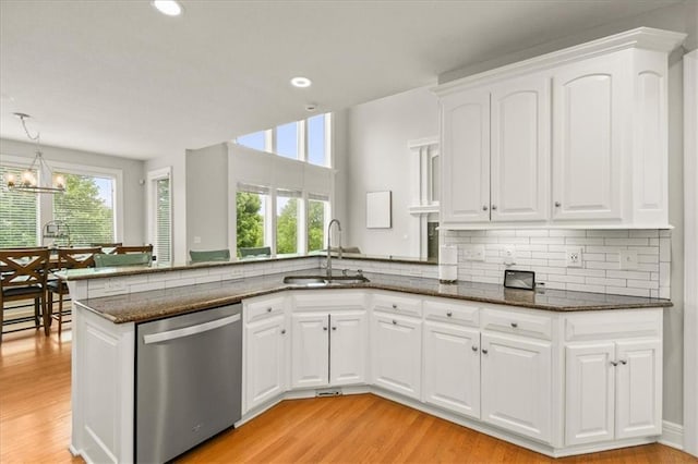 2704 SW Gray Ln, Lees Summit, MO 64081 - kitchen with dishwasher, a sink, dark stone counters, a peninsula, and light wood-type flooring