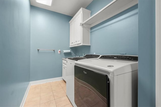 2704 SW Gray Ln, Lees Summit, MO 64081 - washroom featuring cabinet space, washer and dryer, light tile patterned flooring, and baseboards