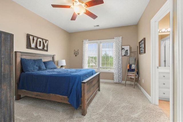 2704 SW Gray Ln, Lees Summit, MO 64081 - bedroom with baseboards, light colored carpet, connected bathroom, and ceiling fan