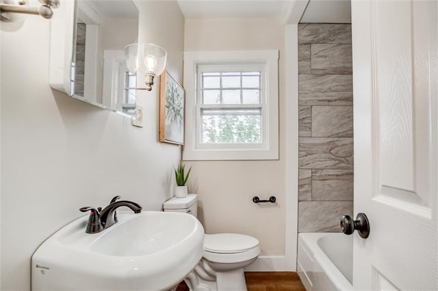 full bathroom with toilet, a sink, and baseboards