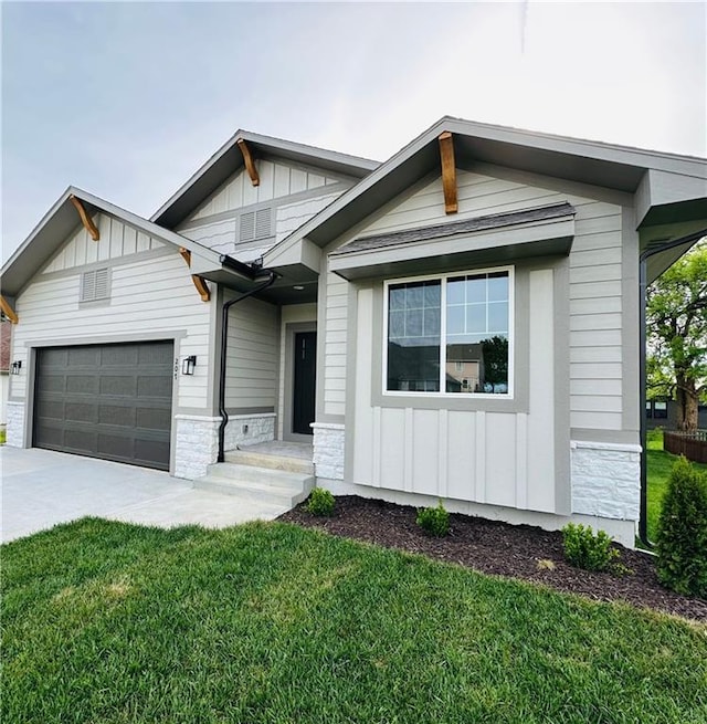 view of front facade featuring a garage, board and batten siding, driveway, and a front lawn