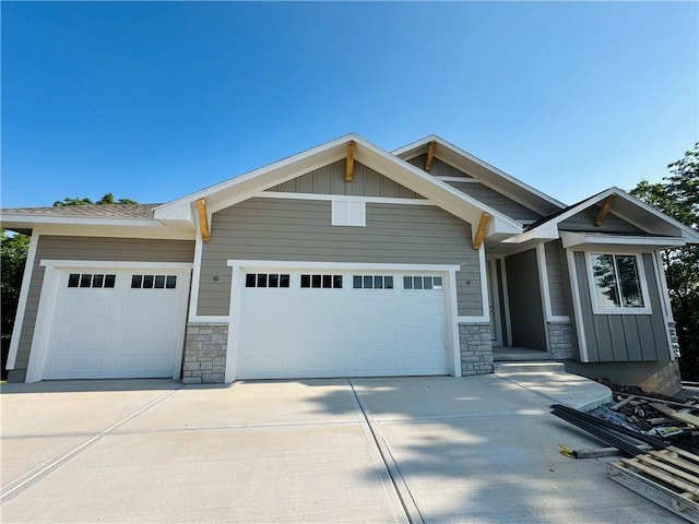 110 E Woodland Ave, Lone Jack, MO 64070 - craftsman-style house featuring an attached garage, stone siding, and driveway
