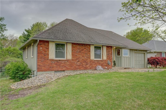 back of property featuring board and batten siding, roof with shingles, a garage, brick siding, and a yard
