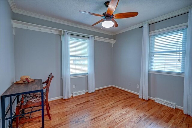 office space with ceiling fan, visible vents, and plenty of natural light