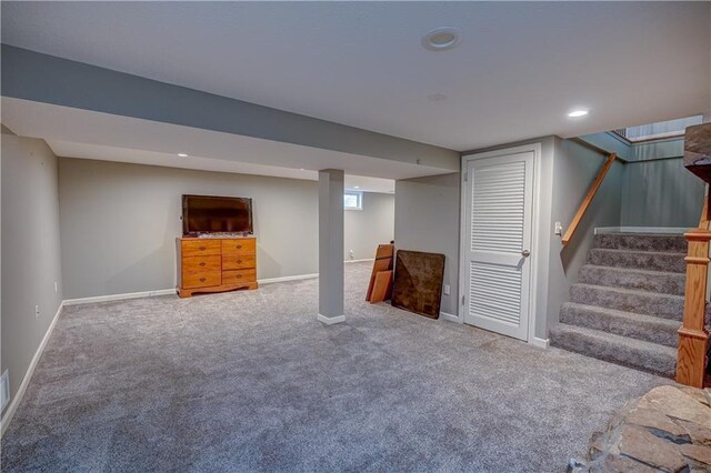 finished below grade area with stairway, carpet floors, and baseboards