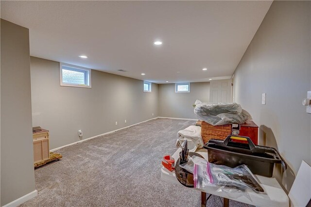 basement with a healthy amount of sunlight, carpet floors, baseboards, and recessed lighting