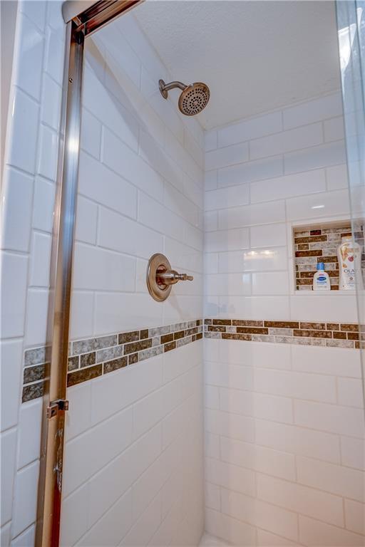 full bathroom with tiled shower