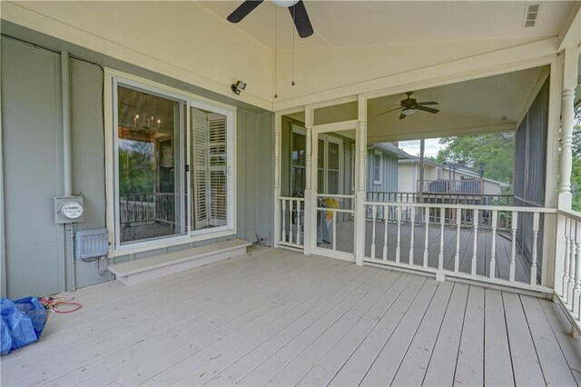 wooden terrace featuring ceiling fan and visible vents