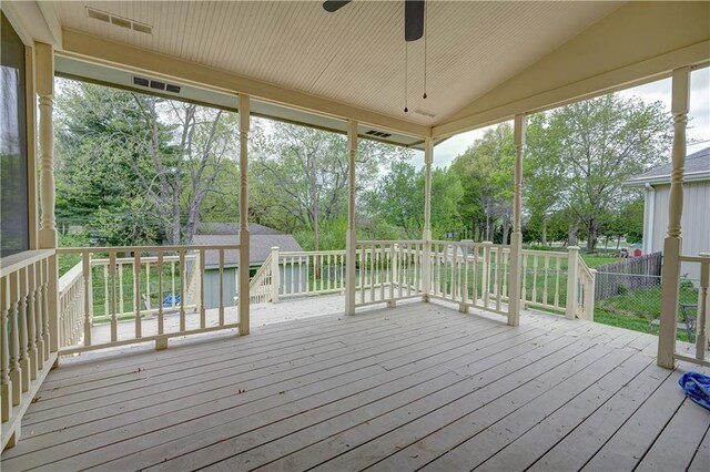 wooden deck with a ceiling fan and visible vents