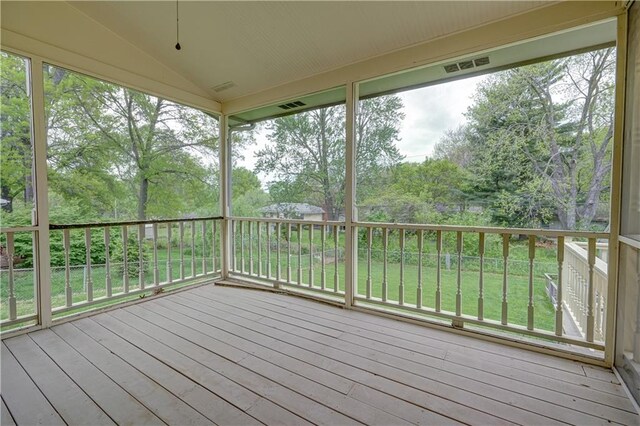 wooden deck featuring visible vents and a lawn