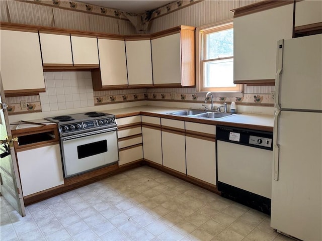 420 S Lincoln Ave, Chanute, KS 66720 - kitchen with a sink, backsplash, white appliances, and light countertops