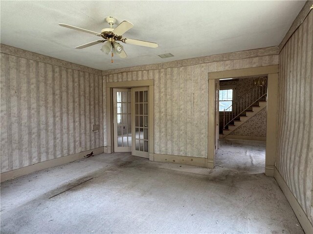 420 S Lincoln Ave, Chanute, KS 66720 - spare room with stairs, a ceiling fan, wallpapered walls, and visible vents