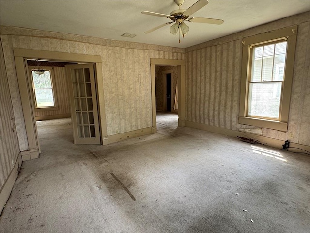 420 S Lincoln Ave, Chanute, KS 66720 - carpeted spare room featuring a ceiling fan, wallpapered walls, and visible vents