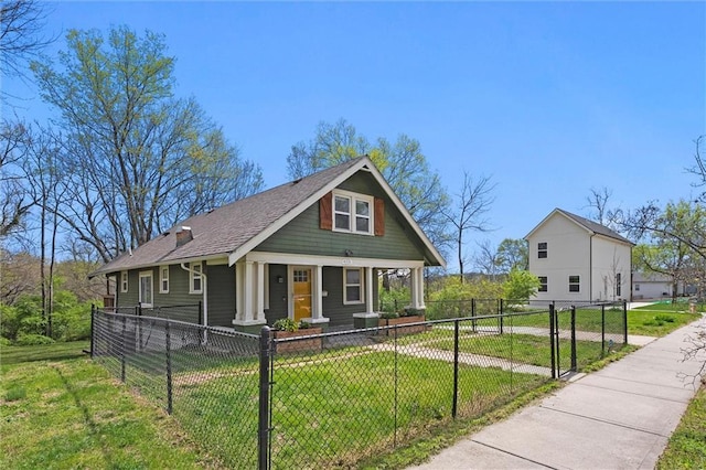 4331 Virginia Ave, Kansas City, MO 64110 - view of front of house with covered porch, roof with shingles, and a gate