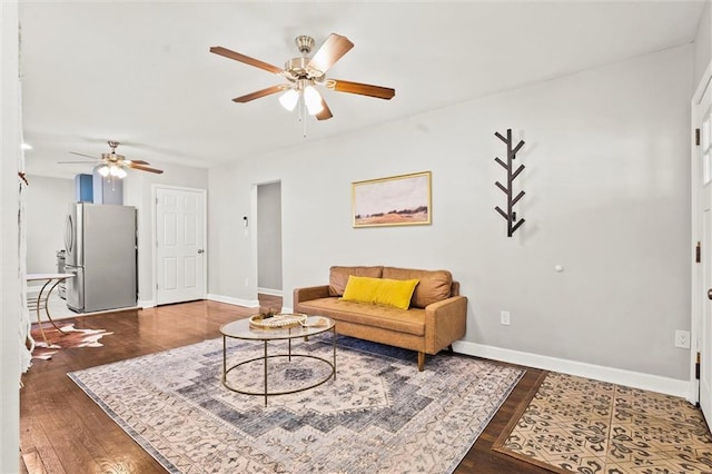 4331 Virginia Ave, Kansas City, MO 64110 - living area featuring a ceiling fan, baseboards, and wood finished floors