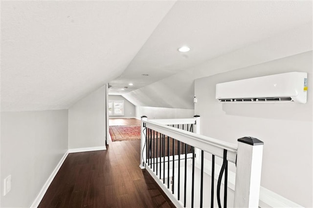 4331 Virginia Ave, Kansas City, MO 64110 - bonus room featuring a wall mounted AC, baseboards, wood finished floors, recessed lighting, and vaulted ceiling