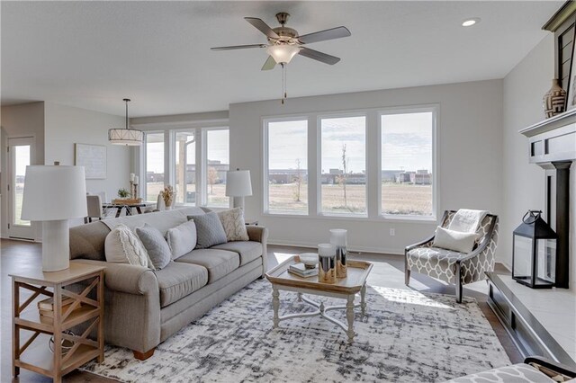 living room with a ceiling fan, recessed lighting, a wealth of natural light, and wood finished floors
