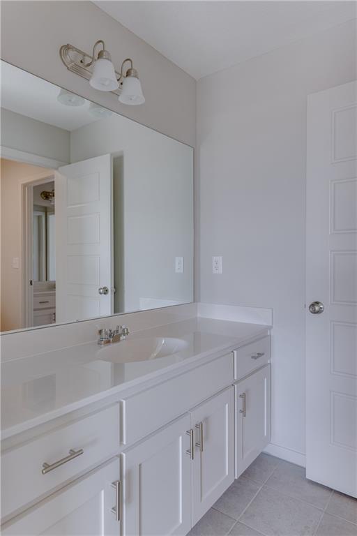 bathroom with tile patterned floors and vanity