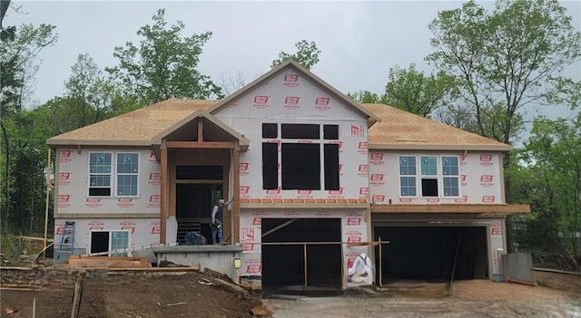 property in mid-construction featuring an attached garage, stucco siding, and driveway