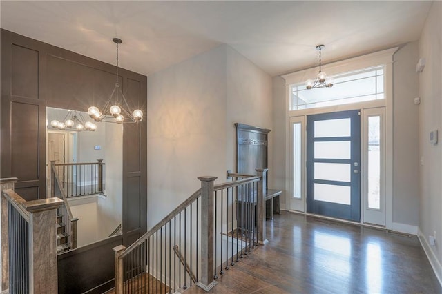 3525 S Woodland Ct, Independence, MO 64052 - foyer entrance featuring baseboards, wood finished floors, and a chandelier