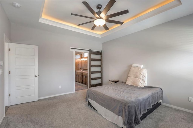 3525 S Woodland Ct, Independence, MO 64052 - bedroom featuring carpet floors, a tray ceiling, a barn door, and baseboards