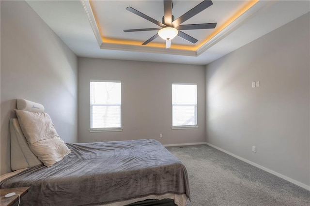 3525 S Woodland Ct, Independence, MO 64052 - carpeted bedroom with a ceiling fan, baseboards, and a raised ceiling