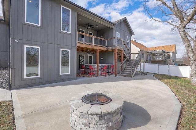 3525 S Woodland Ct, Independence, MO 64052 - rear view of property featuring fence, a patio, stairs, a ceiling fan, and an outdoor fire pit