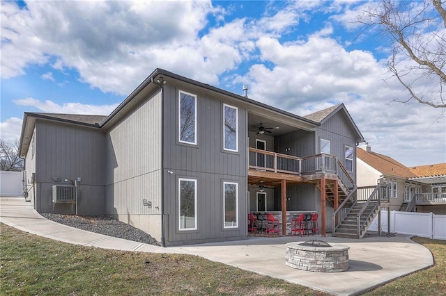 3525 S Woodland Ct, Independence, MO 64052 - rear view of house with ceiling fan, stairway, fence, a patio, and a fire pit