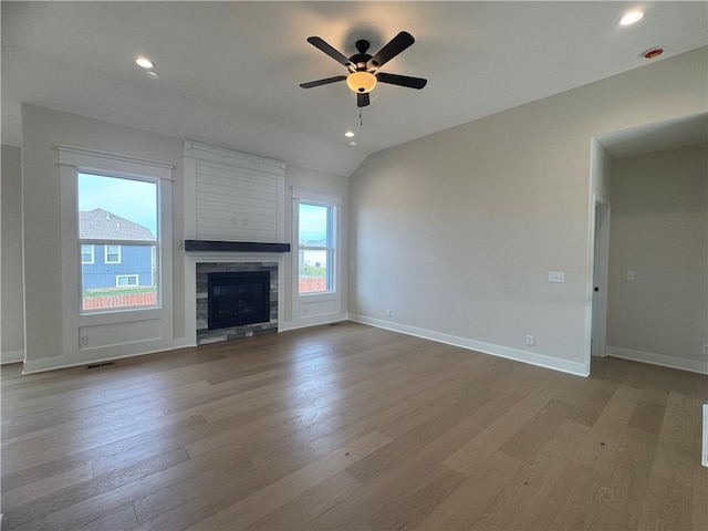 15610 Sheridan Ct, Basehor, KS 66007 - unfurnished living room featuring wood finished floors, a ceiling fan, baseboards, recessed lighting, and a stone fireplace