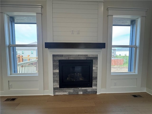 15610 Sheridan Ct, Basehor, KS 66007 - detailed view of wood finished floors, baseboards, and a glass covered fireplace