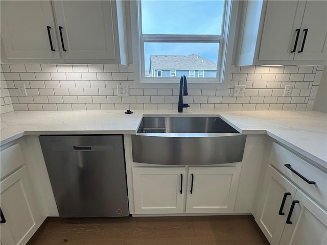 15610 Sheridan Ct, Basehor, KS 66007 - kitchen with stainless steel dishwasher, a sink, white cabinets, and backsplash