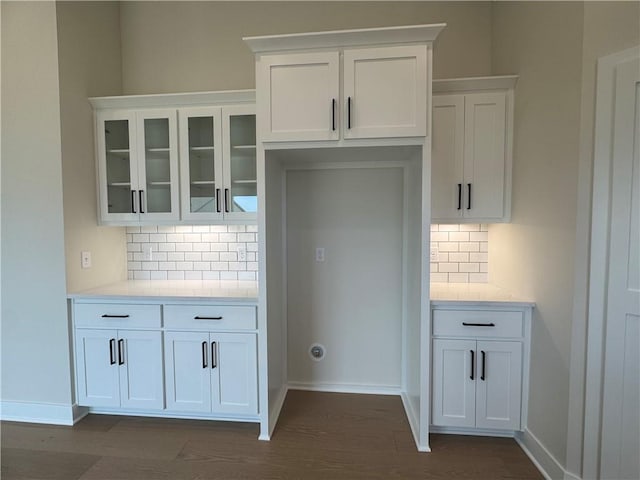 15610 Sheridan Ct, Basehor, KS 66007 - kitchen featuring decorative backsplash, glass insert cabinets, white cabinetry, light countertops, and dark wood-type flooring
