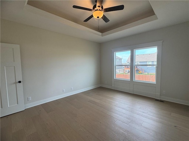 15610 Sheridan Ct, Basehor, KS 66007 - spare room featuring a raised ceiling, hardwood / wood-style floors, baseboards, and ceiling fan