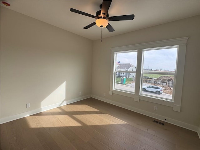 15610 Sheridan Ct, Basehor, KS 66007 - empty room with wood finished floors, a ceiling fan, and baseboards