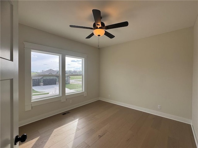 15610 Sheridan Ct, Basehor, KS 66007 - spare room featuring dark wood-style floors, baseboards, and ceiling fan