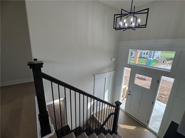 15610 Sheridan Ct, Basehor, KS 66007 - foyer entrance featuring wood finished floors, healthy amount of natural light, a chandelier, stairs, and a towering ceiling