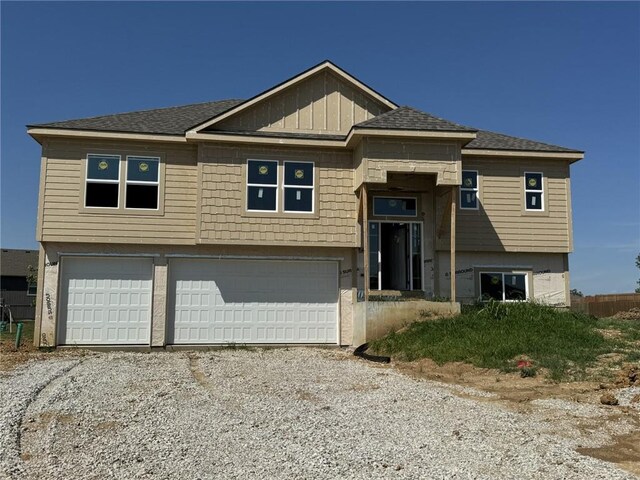 15610 Sheridan Ct, Basehor, KS 66007 - bi-level home with a garage, driveway, and a shingled roof