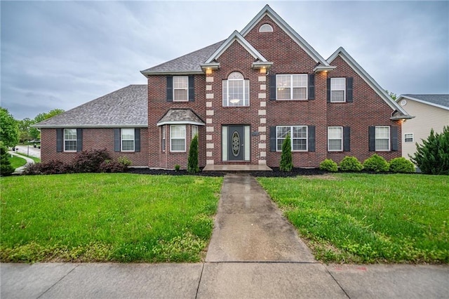 2500 Gabrianna Ct, Columbia, MO 65203 - colonial inspired home featuring brick siding, a shingled roof, and a front lawn