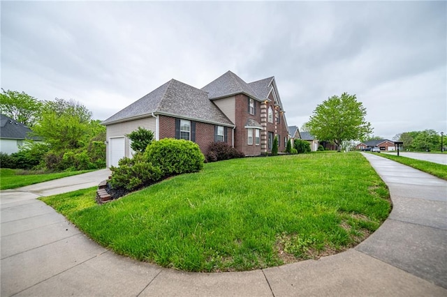 2500 Gabrianna Ct, Columbia, MO 65203 - view of side of home with a lawn, roof with shingles, brick siding, concrete driveway, and an attached garage