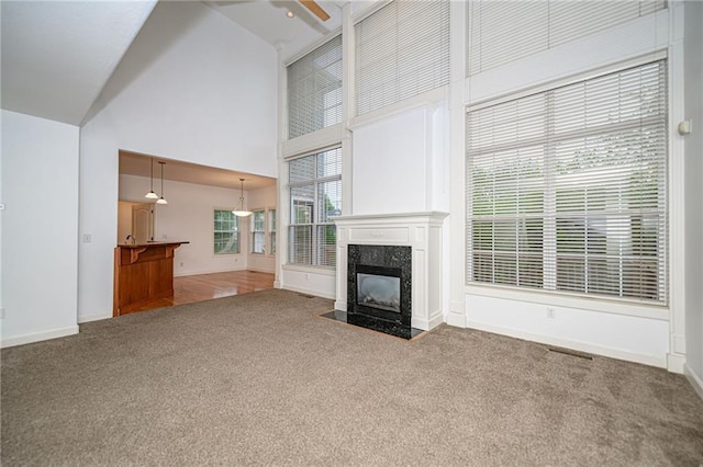 2500 Gabrianna Ct, Columbia, MO 65203 - unfurnished living room with carpet floors, a high end fireplace, baseboards, and a towering ceiling