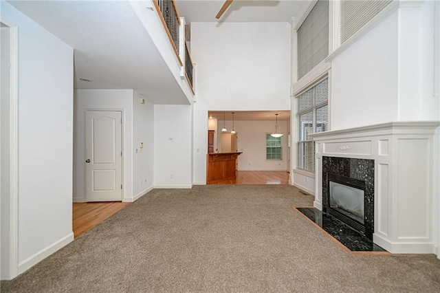 2500 Gabrianna Ct, Columbia, MO 65203 - unfurnished living room featuring carpet floors, a high ceiling, baseboards, and a fireplace