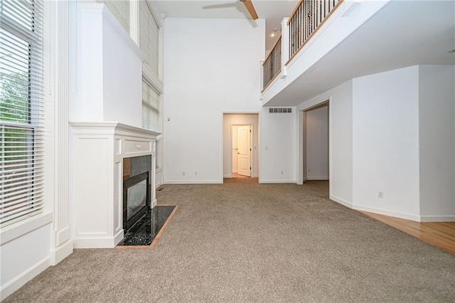 2500 Gabrianna Ct, Columbia, MO 65203 - unfurnished living room with a high end fireplace, a wealth of natural light, carpet, and visible vents